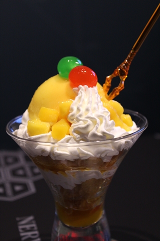 「Food No.11零号機のパフェ／690円。零号機をイメージしたパフェ。マンゴーアイスとクリームが絶妙！」マンゴーのフルーティな味が口いっぱいに広がる感覚が楽しい。これを食べればレイがあなたを守ってくれる……かも？